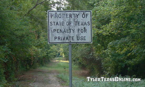 Photo of the abandoned railroad right-of-way showing overgrown conditions in Gresham, Texas 