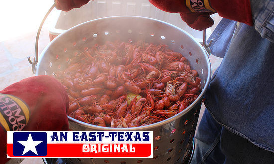 The boil is done! Lifting the crawfish from the pot